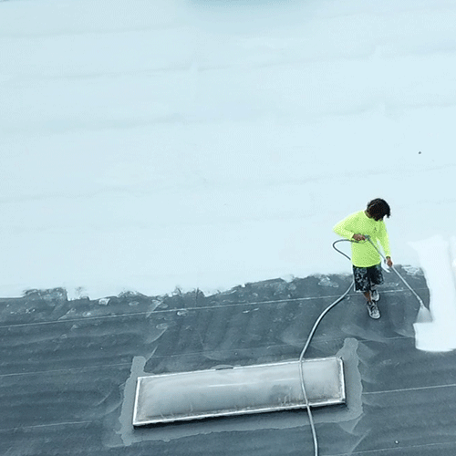 A Roofer Sprays Acrylic Roof Coating